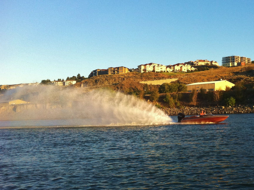 A high-performance boat crossing a lake